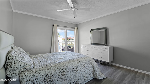 bedroom with a textured ceiling, ceiling fan, dark hardwood / wood-style floors, and crown molding