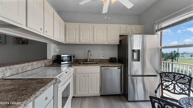 kitchen featuring white cabinetry, stainless steel appliances, and light hardwood / wood-style floors