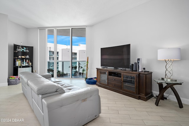 living room with light wood-type flooring and floor to ceiling windows