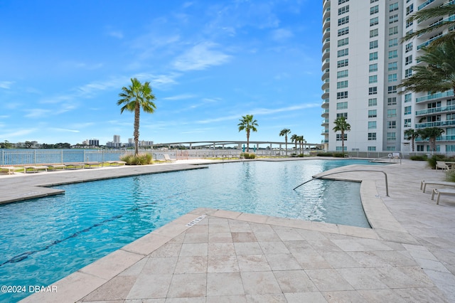 view of swimming pool with a water view