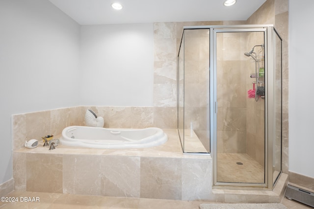 bathroom with tile patterned flooring and shower with separate bathtub
