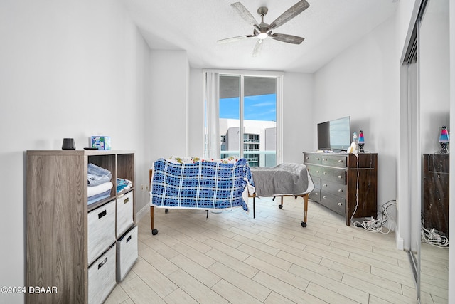interior space featuring light hardwood / wood-style floors, ceiling fan, and a textured ceiling
