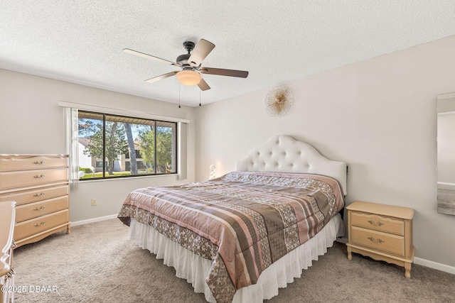 1 Tomoka Oaks Blvd Unit 112, Ormond Beach, FL 32174 - bedroom with light carpet, baseboards, a textured ceiling, and a ceiling fan