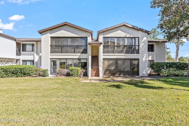1 Tomoka Oaks Blvd Unit 112, Ormond Beach, FL 32174 - back of property featuring stucco siding, a yard, and stairs