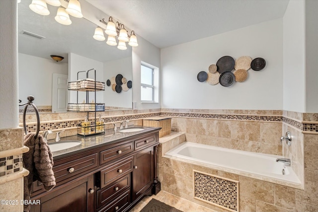 bathroom with vanity and tiled bath