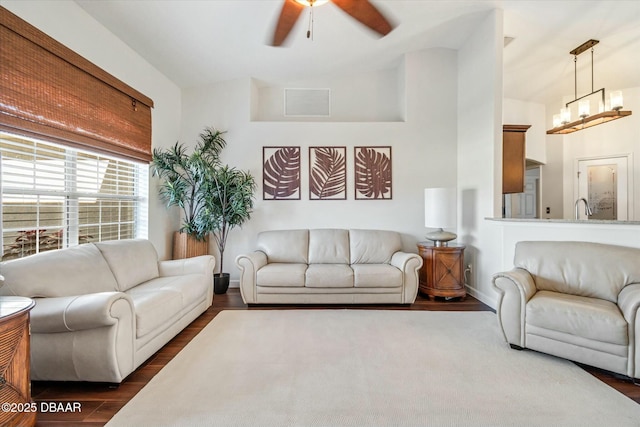 living room with sink, ceiling fan with notable chandelier, and dark hardwood / wood-style floors