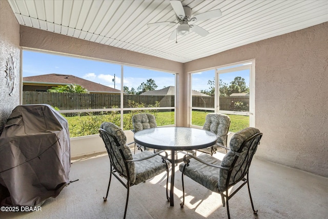 sunroom featuring ceiling fan and a healthy amount of sunlight