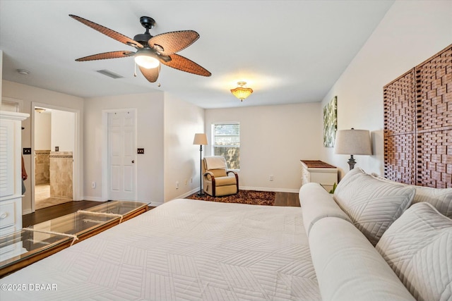 bedroom with hardwood / wood-style flooring, ceiling fan, and ensuite bath