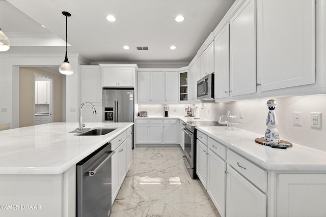 kitchen with visible vents, marble finish floor, ornamental molding, a sink, and appliances with stainless steel finishes