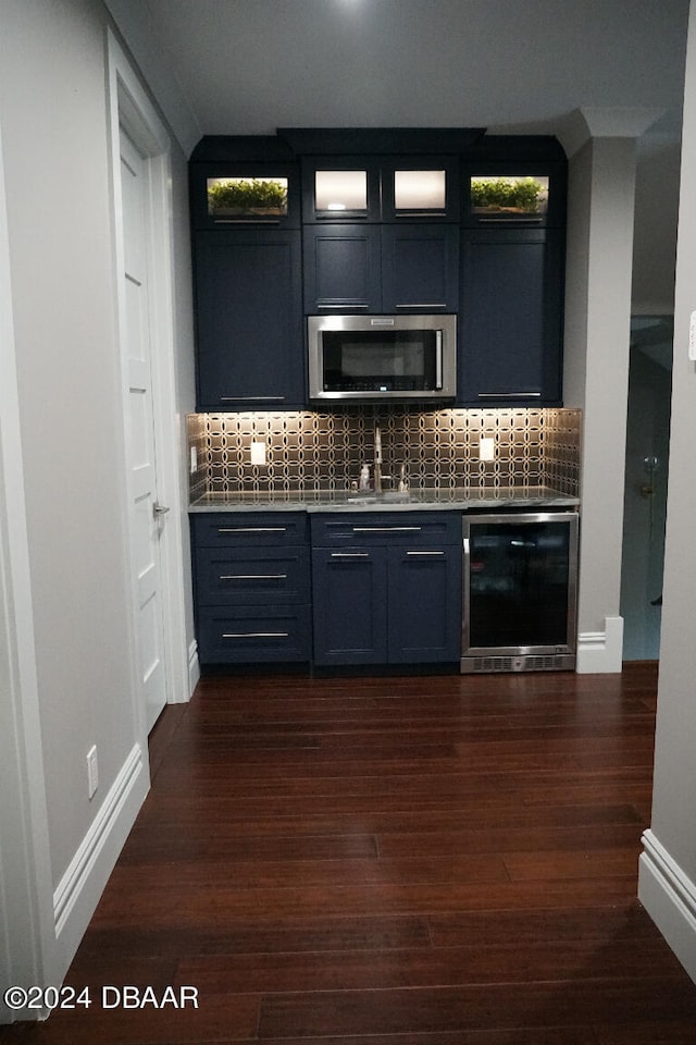 bar featuring tasteful backsplash, wine cooler, sink, and dark hardwood / wood-style floors