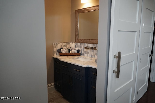 bathroom featuring vanity and backsplash