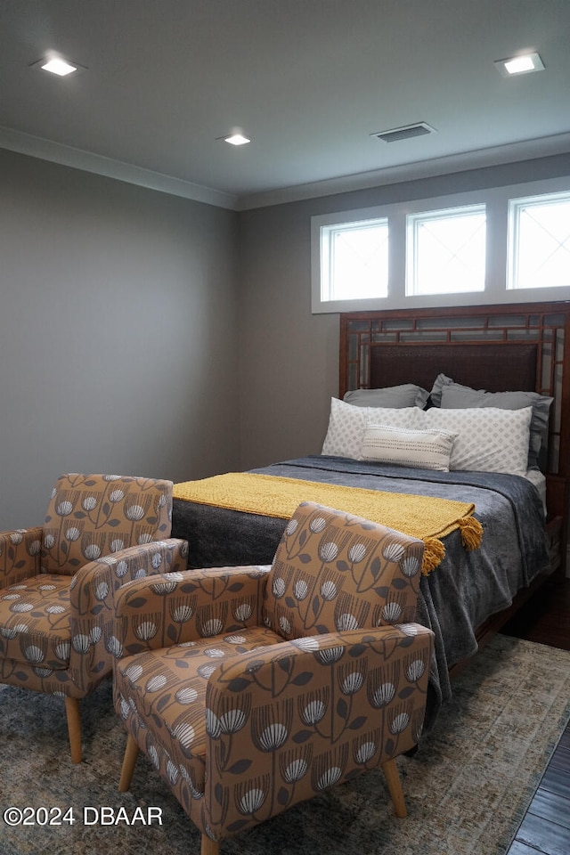 bedroom featuring dark hardwood / wood-style floors and crown molding