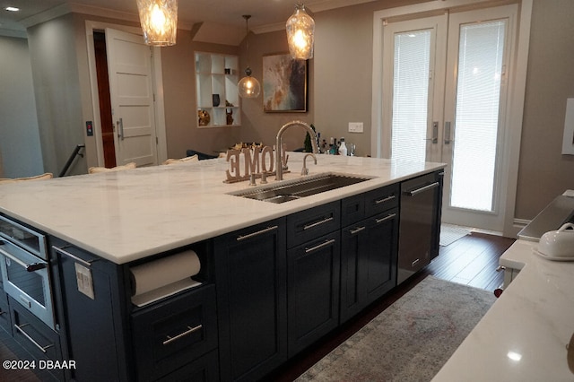 kitchen with light stone countertops, dishwasher, sink, dark wood-type flooring, and decorative light fixtures