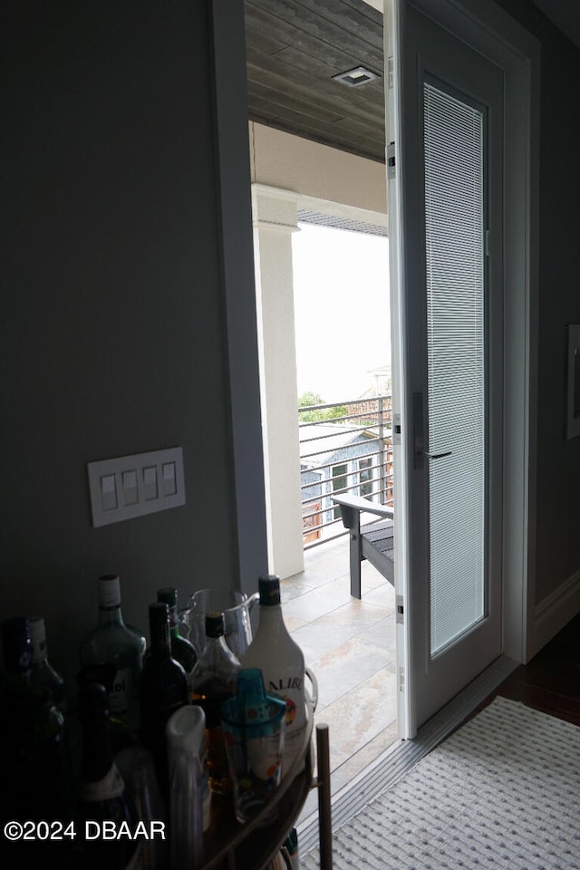 doorway to outside with wood ceiling