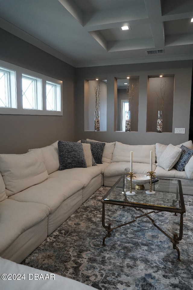 living room featuring beamed ceiling, ornamental molding, and coffered ceiling