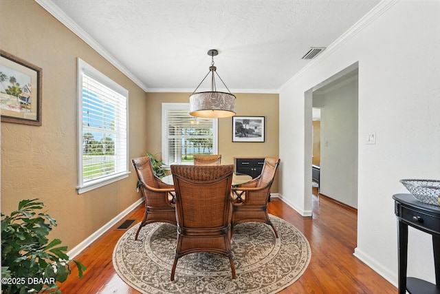 1146 Riverside Dr, Holly Hill, FL 32117 - dining space featuring wood finished floors and ornamental molding
