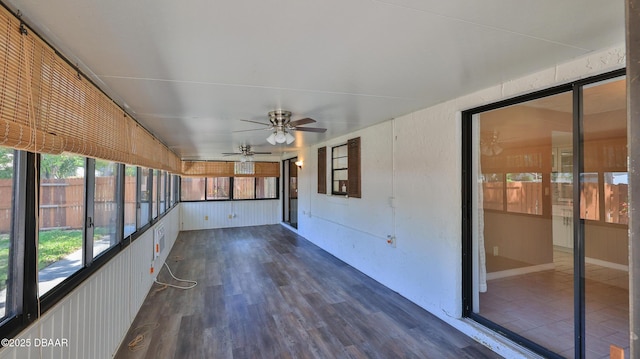unfurnished sunroom featuring a ceiling fan