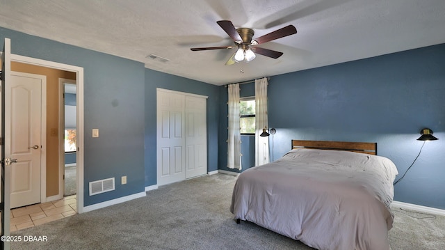 bedroom featuring visible vents, a closet, carpet flooring, and baseboards