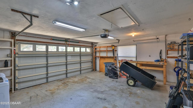 garage featuring a garage door opener and washer / clothes dryer