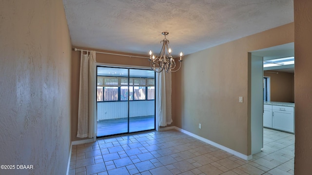 unfurnished room featuring a chandelier, baseboards, light tile patterned floors, and a textured ceiling