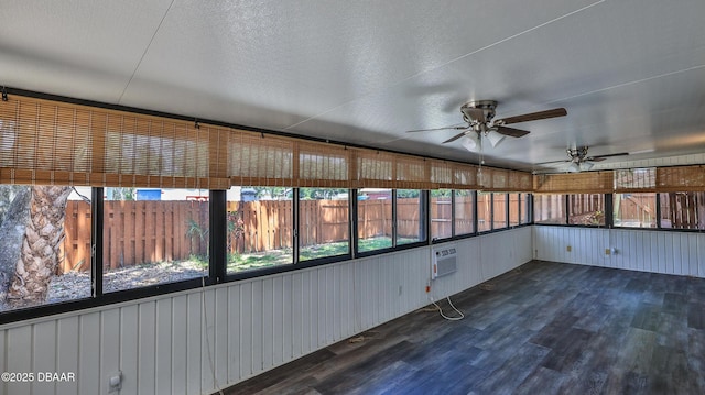 unfurnished sunroom featuring ceiling fan