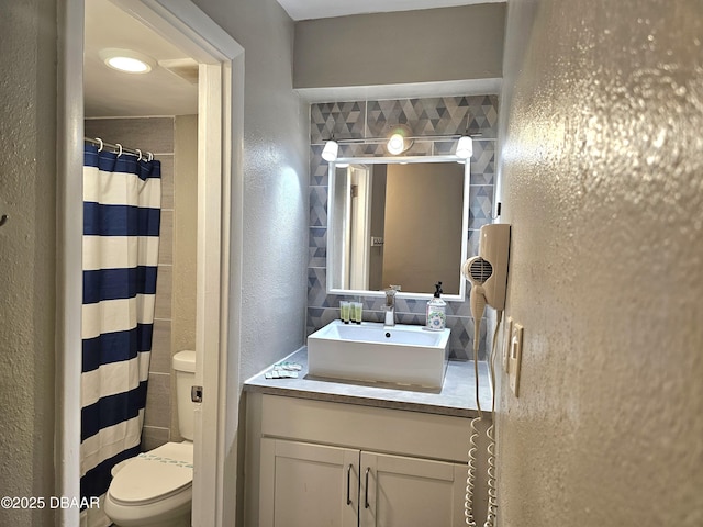 bathroom with walk in shower, vanity, and toilet