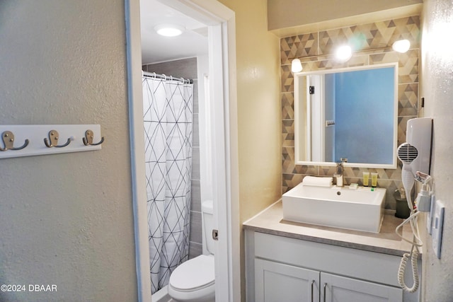 bathroom featuring decorative backsplash, vanity, toilet, and a shower with shower curtain