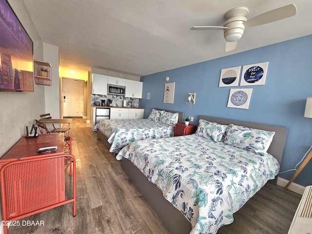 bedroom with dark hardwood / wood-style floors and ceiling fan