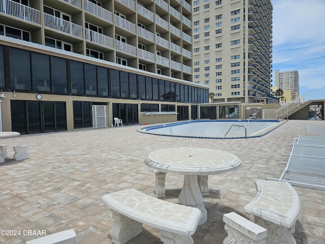 view of swimming pool with a patio