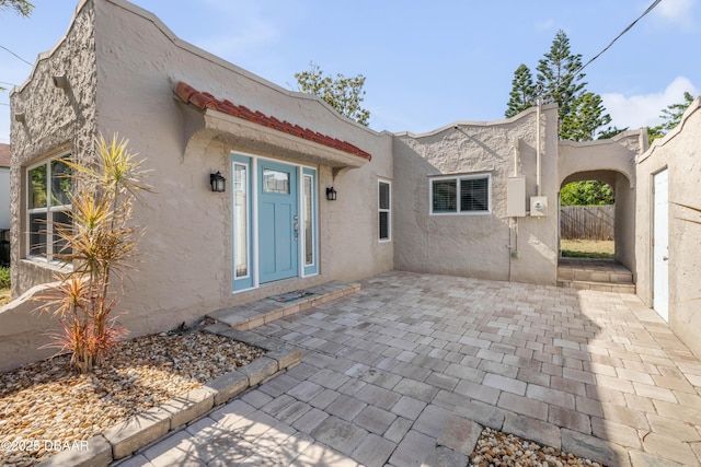 view of front facade featuring a patio area and stucco siding