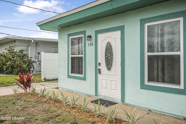 property entrance featuring stucco siding