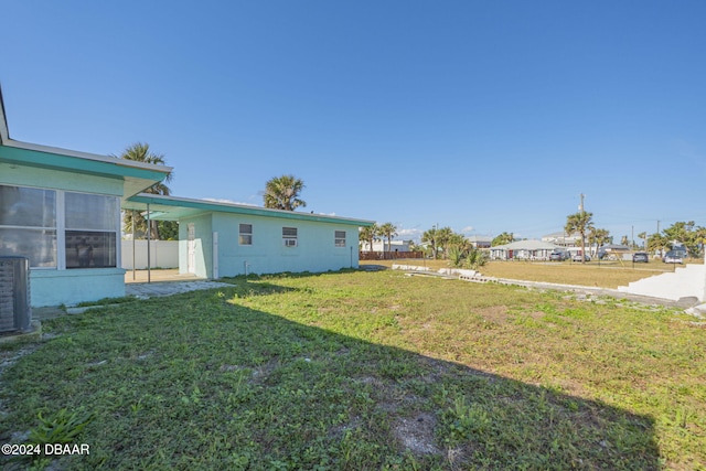 view of yard with cooling unit and fence