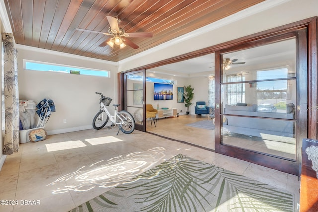 workout room with ornamental molding, a wealth of natural light, wood ceiling, and baseboards