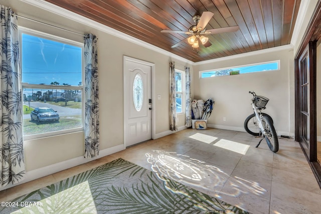 entrance foyer with plenty of natural light, wood ceiling, and crown molding