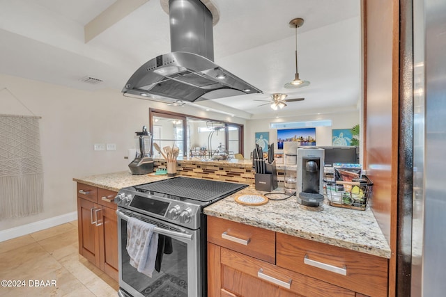 kitchen featuring brown cabinetry, stainless steel electric range oven, light stone counters, island exhaust hood, and pendant lighting