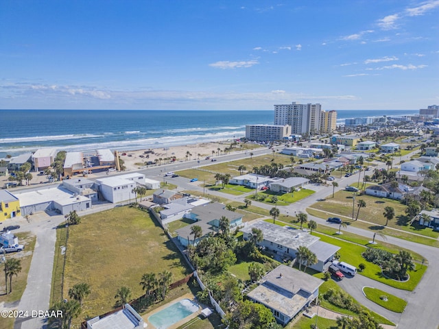 birds eye view of property with a beach view and a water view