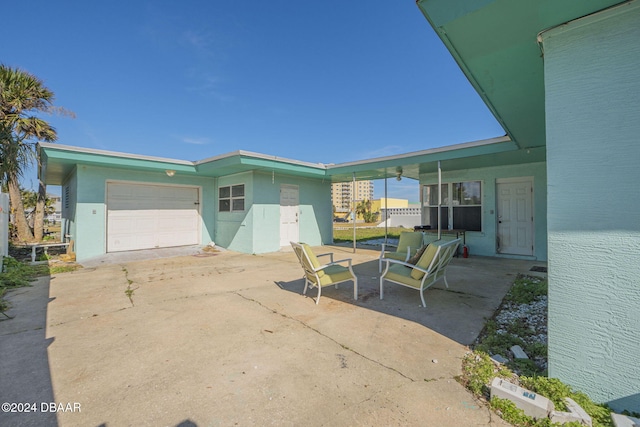 view of patio with a garage and concrete driveway