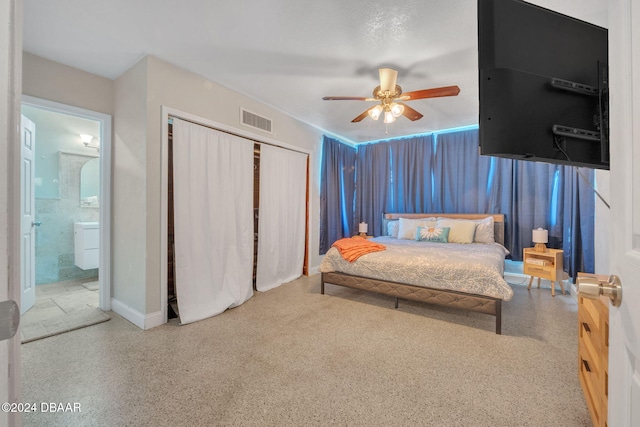 bedroom featuring a closet, visible vents, ensuite bath, and speckled floor