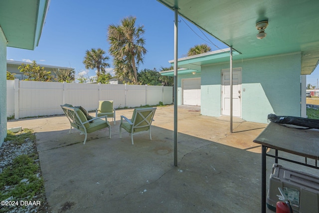 view of patio featuring a garage and a fenced backyard