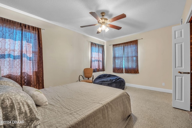 bedroom featuring ceiling fan, baseboards, and a textured ceiling