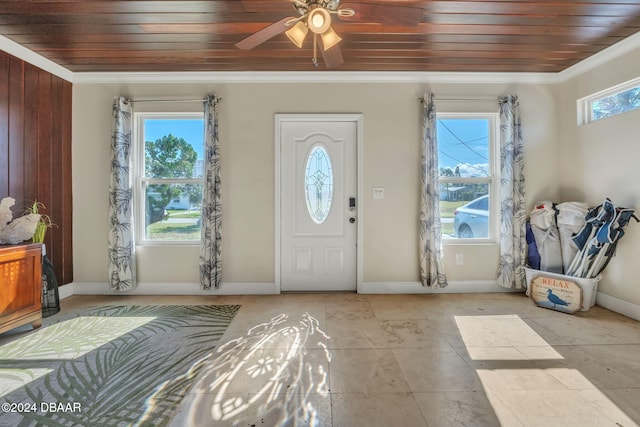 entrance foyer with ornamental molding, wood ceiling, and baseboards