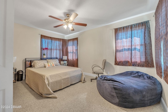 bedroom with crown molding, a ceiling fan, and baseboards