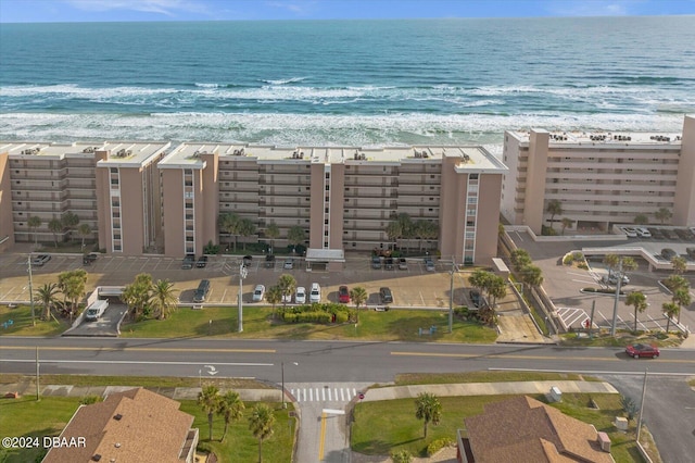 birds eye view of property with a view of the beach and a water view