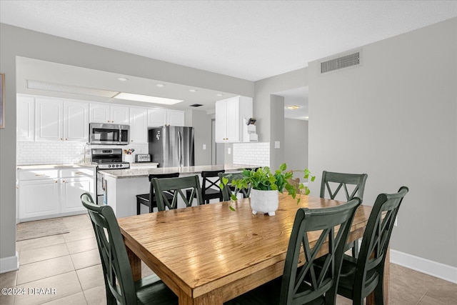 4445 S Atlantic Ave Unit 606, Ponce Inlet, FL 32127 - dining area with light tile patterned floors and baseboards