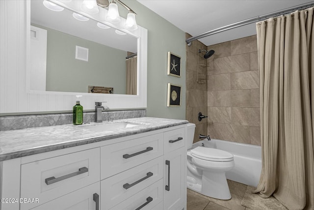 full bathroom featuring vanity, tile patterned flooring, toilet, and shower / tub combo