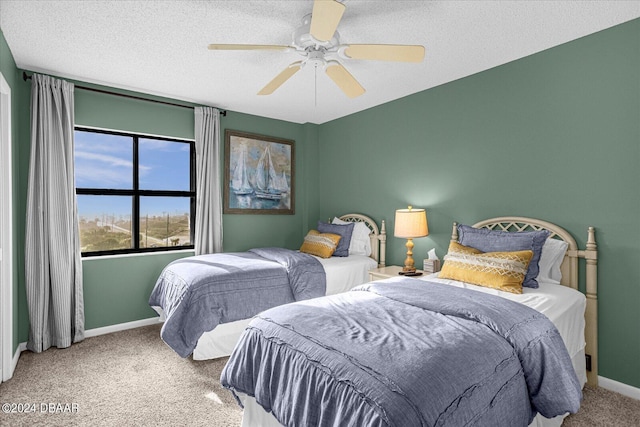 4445 S Atlantic Ave Unit 606, Ponce Inlet, FL 32127 - bedroom with carpet flooring, baseboards, a ceiling fan, and a textured ceiling