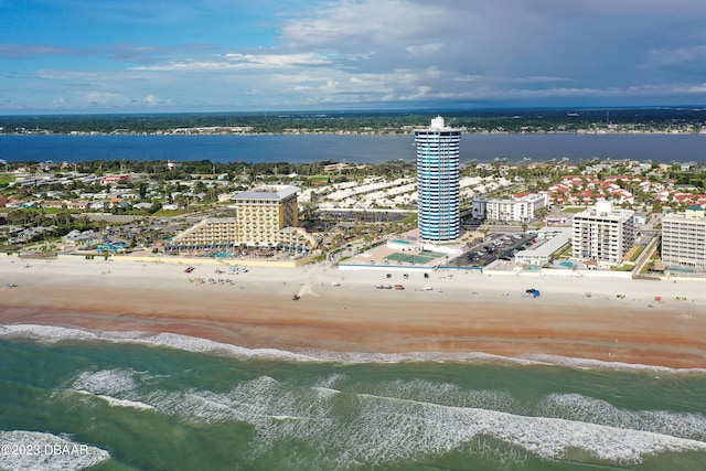 bird's eye view with a water view and a beach view