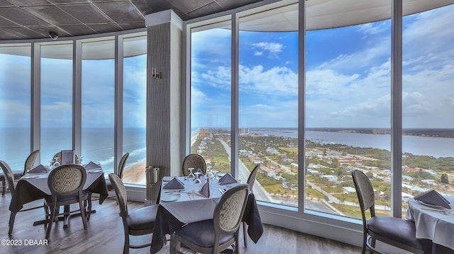 sunroom featuring a water view