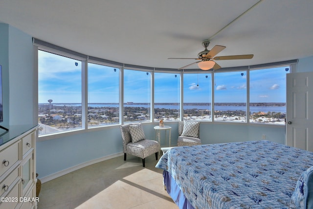 bedroom with ceiling fan and light tile patterned flooring