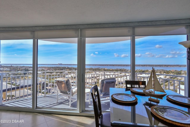 unfurnished sunroom with a water view and a wealth of natural light